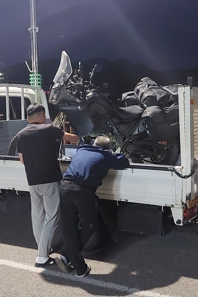 Loading motorcycle on small truck, Daegu, South Korea