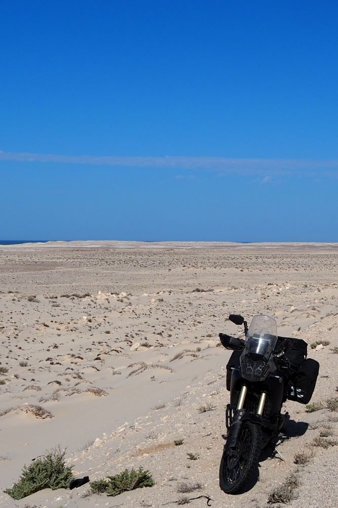 Black adventure motorcycle in Western Sahara desert