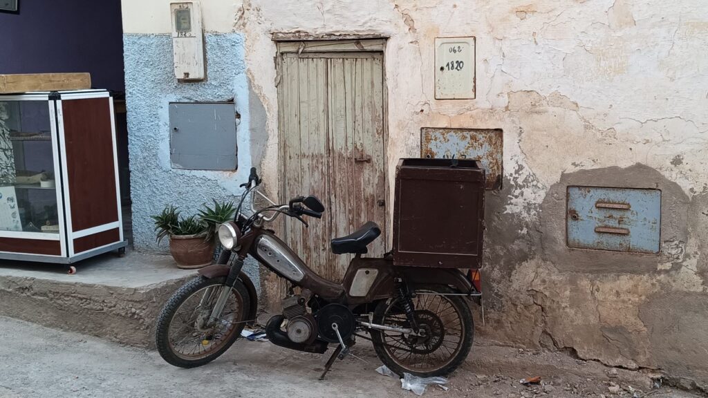 A small motorbike parked in the streets of Sidi Ifni, Morocco